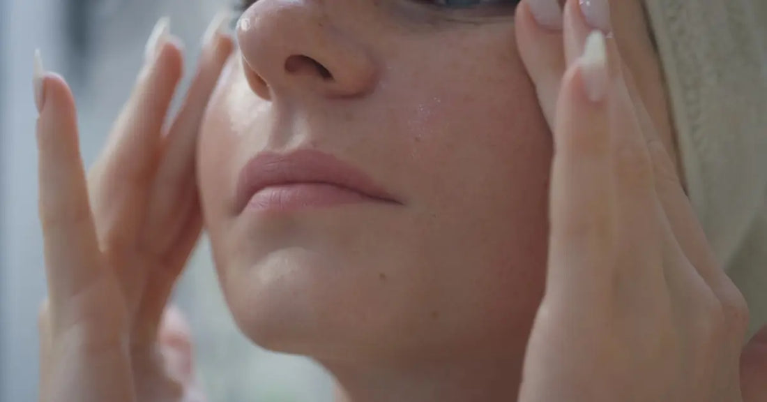 Woman applying lightweight moisturizer on oily skin as part of a daily skincare routine for balanced and healthy-looking skin