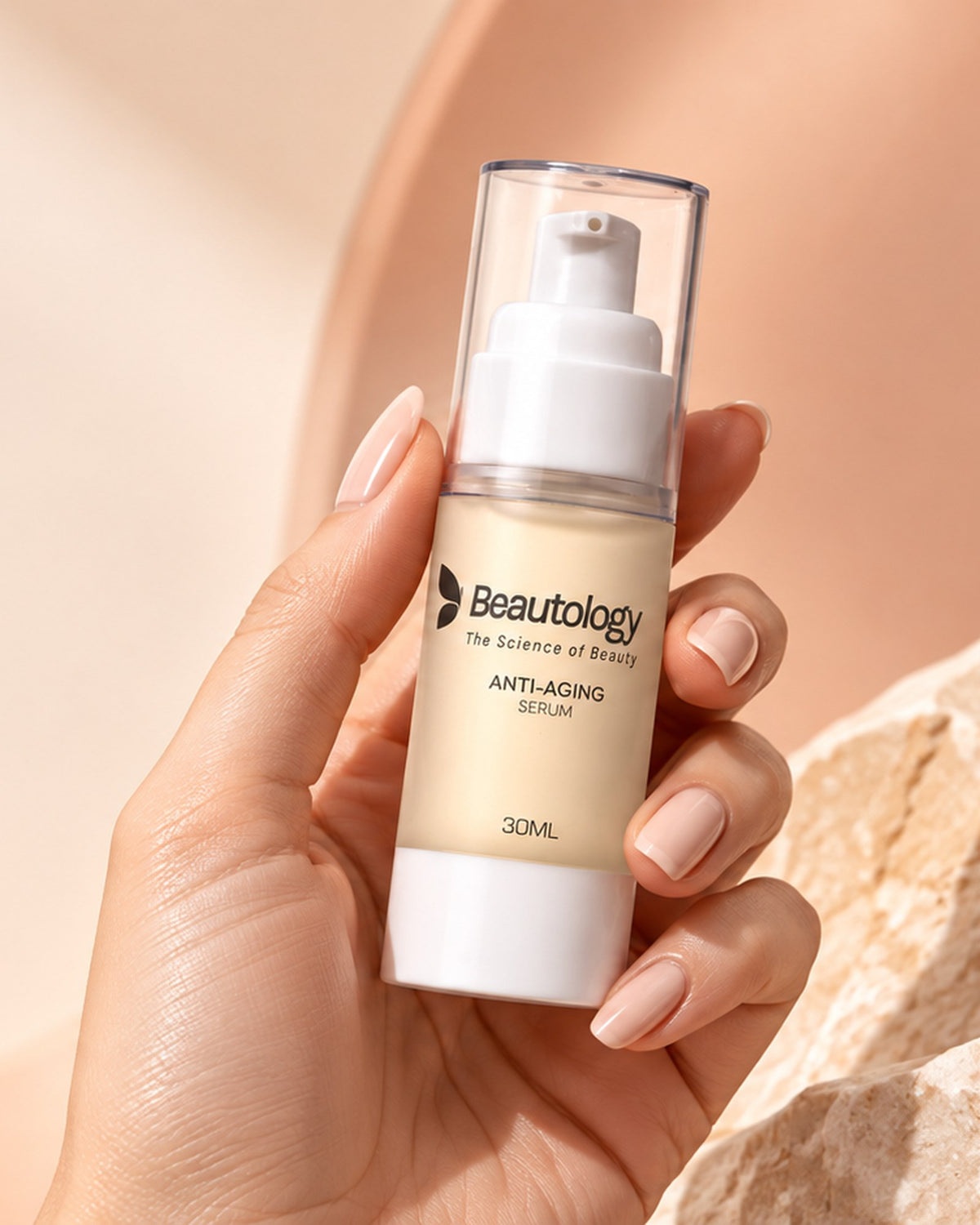 A hand holding the Beautology Anti-Aging Serum bottle