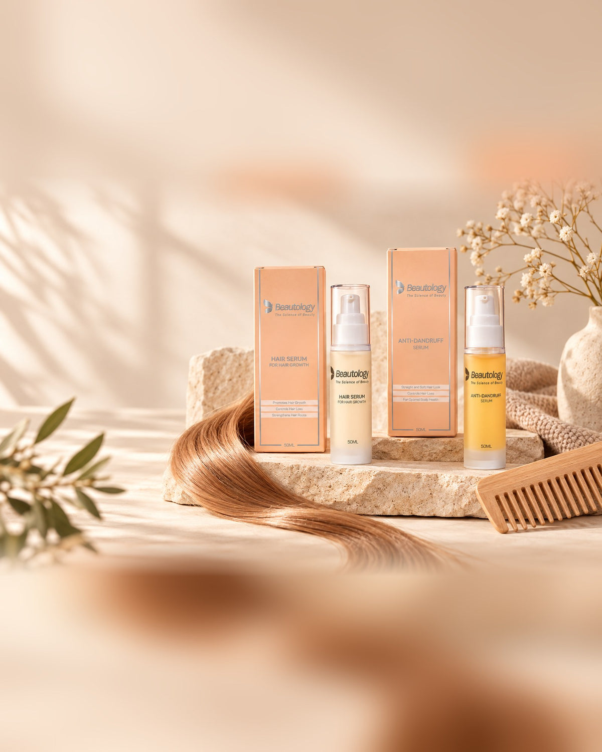 The Beautology hair care range with a strand of hair and a wooden comb on a stone plinth