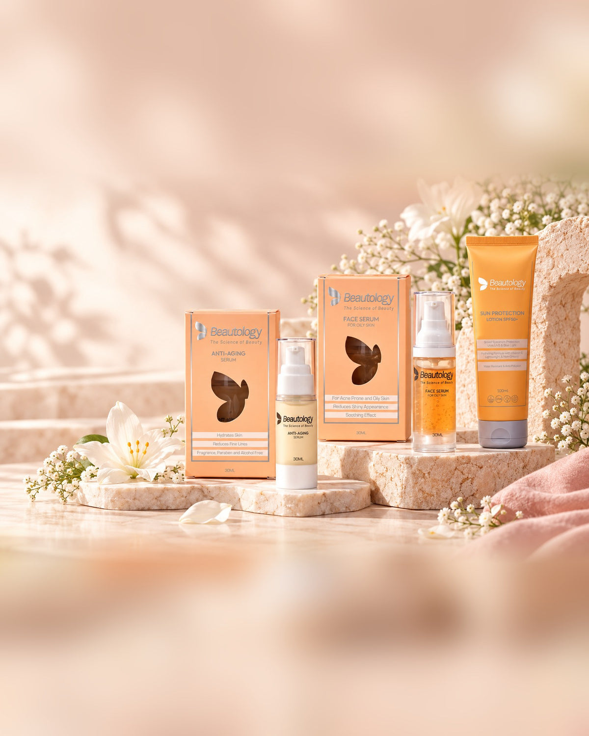 The Beautology skin care range on stone plinths with white flowers
