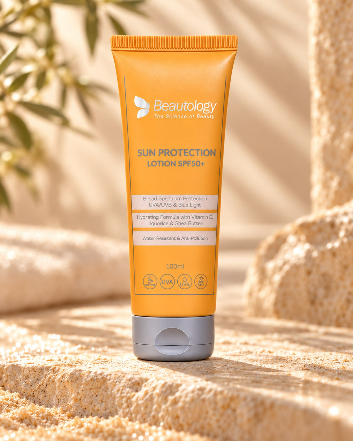Beautology Sun Protection Lotion SPF50+ tube standing on sunlit sandy stone