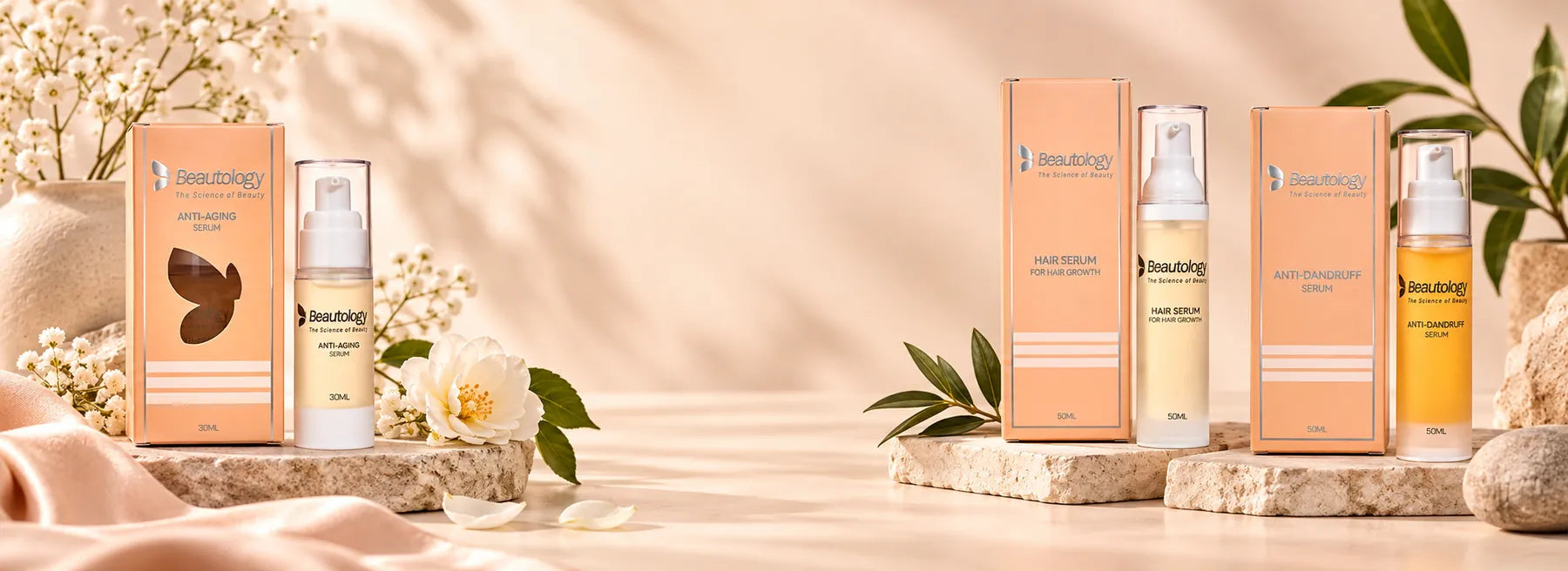 Beautology skin care and hair care serums arranged on stone plinths with soft botanicals.